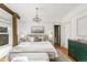 Spacious main bedroom with white walls, neutral bedding, and a pop of color from the dresser at 3015 Lowell Blvd, Denver, CO 80211