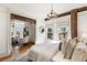 Sunlit main bedroom with decorative trimwork and adjoining sitting room and fireplace at 3015 Lowell Blvd, Denver, CO 80211