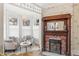Cozy sitting area featuring a fireplace, large windows with leaded glass, and vintage wallpaper at 3015 Lowell Blvd, Denver, CO 80211