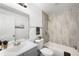 Renovated bathroom featuring tiled walls, updated fixtures, and modern design at 1180 Newark St, Aurora, CO 80010