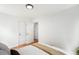 Bright bedroom featuring hardwood floors and white walls, with closet and ensuite access at 1180 Newark St, Aurora, CO 80010