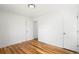 Clean bedroom with hardwood floors, white walls, and two closets/entry doors at 1180 Newark St, Aurora, CO 80010
