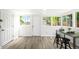 Sunlit dining area with minimalist furniture and light wood floors at 1180 Newark St, Aurora, CO 80010