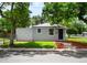 Beautifully landscaped front yard with mulch and a freshly painted exterior at 1180 Newark St, Aurora, CO 80010
