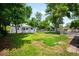 Charming single-story home with a well-maintained lawn and mature trees at 1180 Newark St, Aurora, CO 80010