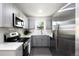 Well-lit kitchen featuring stainless steel appliances and ample counter space at 1180 Newark St, Aurora, CO 80010