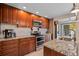 Updated kitchen featuring stainless steel appliances, granite countertops, and ample cabinet space at 930 S Eliot St, Denver, CO 80219