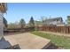 Back yard with wooden fence, stone patio, lawn and mature trees at 20521 E Bellewood Pl, Aurora, CO 80015