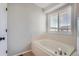 Bathroom with a bright soaking tub and large window at 20521 E Bellewood Pl, Aurora, CO 80015