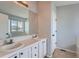 Bathroom featuring double sinks, tile countertops, and a large mirror at 20521 E Bellewood Pl, Aurora, CO 80015