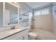 Bright bathroom with a single sink vanity, tub and shower combo, and a large mirror at 20521 E Bellewood Pl, Aurora, CO 80015