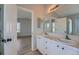 Bathroom featuring double sinks, tile countertops, and a door to the bedroom at 20521 E Bellewood Pl, Aurora, CO 80015