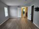 Bedroom featuring light gray walls, wood-look floors, with open door looking at hallway and staircase at 20521 E Bellewood Pl, Aurora, CO 80015