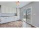 Bright kitchen area with tile floors, cabinets, granite countertops, and access to the backyard patio at 20521 E Bellewood Pl, Aurora, CO 80015