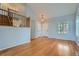 Bright living room with wood floors, staircase, pendant light and double front entry doors at 20521 E Bellewood Pl, Aurora, CO 80015