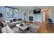 Bright living room featuring a cozy fireplace, large window, and stylish modern furniture at 20521 E Bellewood Pl, Aurora, CO 80015