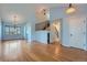 Spacious living room with hardwood floors, high ceilings, modern lighting and staircase to the second level at 20521 E Bellewood Pl, Aurora, CO 80015