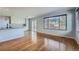 Inviting living space featuring wood floors that seamlessly connect to a modern kitchen with granite countertops at 20521 E Bellewood Pl, Aurora, CO 80015