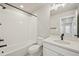 Modern bathroom showcasing tiled shower-tub, sleek fixtures, and vanity with bright lighting at 6225 N Nepal Ct, Aurora, CO 80019