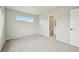 Bedroom featuring a neutral carpet, window and door to the bathroom at 6225 N Nepal Ct, Aurora, CO 80019
