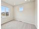 Bright bedroom featuring neutral tones, plush carpeting, and natural light from two windows at 6225 N Nepal Ct, Aurora, CO 80019