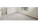Bedroom with soft neutral carpet, window view, and door to walk-in closet at 6225 N Nepal Ct, Aurora, CO 80019