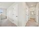 Upstairs hallway with neutral carpet and white doors leading to bedrooms and bathrooms at 6225 N Nepal Ct, Aurora, CO 80019