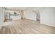 Living space view shows staircase, kitchen, and bright wood floors throughout at 6225 N Nepal Ct, Aurora, CO 80019