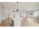 Living space view includes kitchen with island, pendant lights, and stainless steel appliances at 6225 N Nepal Ct, Aurora, CO 80019