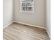 An empty room with wood flooring and a window overlooking a neighboring house at 6225 N Nepal Ct, Aurora, CO 80019