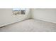 Bright empty room with neutral carpet and two windows at 6225 N Nepal Ct, Aurora, CO 80019