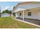 Charming backyard view showcasing the covered patio and detached garage at 4465 S Bannock St, Englewood, CO 80110