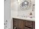 Charming bathroom featuring a wood vanity, decorative mirror and shower with subway tiles at 4465 S Bannock St, Englewood, CO 80110