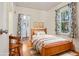 Comfortable bedroom featuring hardwood floors, a cozy bed, and classic accents at 4465 S Bannock St, Englewood, CO 80110