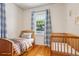 Cozy bedroom staged with bed and crib, showcasing the room's potential as a Bedroom at 4465 S Bannock St, Englewood, CO 80110