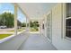 Long, airy covered porch with views of the neighborhood, perfect for enjoying the outdoors at 4465 S Bannock St, Englewood, CO 80110