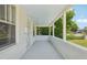 Spacious covered porch featuring white pillars and ample room for seating and relaxation at 4465 S Bannock St, Englewood, CO 80110