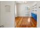 Open dining area showcasing hardwood floors, and an archway leading to the kitchen at 4465 S Bannock St, Englewood, CO 80110