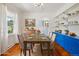 Staged dining room features hardwood floors, stylish chairs, and an archway to the kitchen at 4465 S Bannock St, Englewood, CO 80110