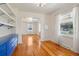 Bright dining room with hardwood floors, custom blue cabinet, and an archway at 4465 S Bannock St, Englewood, CO 80110