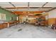 Large garage space with workbench, exposed ceiling, and ample storage at 4465 S Bannock St, Englewood, CO 80110