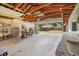 Spacious garage with open ceiling, work area, and roll-up door to backyard at 4465 S Bannock St, Englewood, CO 80110