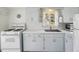 Charming kitchen features white appliances, ample counter space, and classic cabinets at 4465 S Bannock St, Englewood, CO 80110