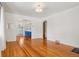 Clean, bright living room with gleaming hardwood floors and access to other rooms at 4465 S Bannock St, Englewood, CO 80110
