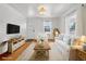 Bright living room features hardwood floors, a comfortable white sofa, and ample natural light at 4465 S Bannock St, Englewood, CO 80110