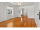 Bright living room with hardwood floors, classic archway, and large window with natural light at 4465 S Bannock St, Englewood, CO 80110