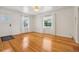 Light-filled living room featuring polished hardwood floors, white walls, and natural light from large windows at 4465 S Bannock St, Englewood, CO 80110