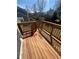 A clear wooden deck with handrails overlooking a grassy backyard and surrounding neighborhood at 5971 S Tabor St, Littleton, CO 80127