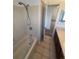 Bathroom with a shower and bathtub, tile surround, toilet, and vanity at 5971 S Tabor St, Littleton, CO 80127