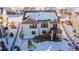 Aerial view of house showcasing backyard, deck, and playground in a snowy setting at 23579 E Swallow Cir, Aurora, CO 80016